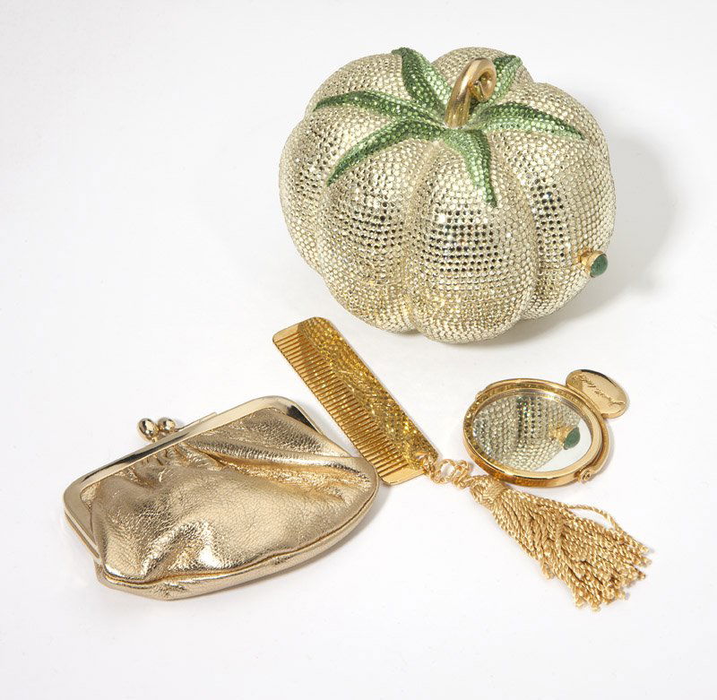 A crystal tomato minaudiere, Judith Leiber: Each item signed Judith Leiber; light green tomato minaudiere comes with chain, coinpurse, mirror, and comb still in tissue; accompanied with a signed pouch and dustbag. 3'' H x 3.5'' W x 3'' D. est:$