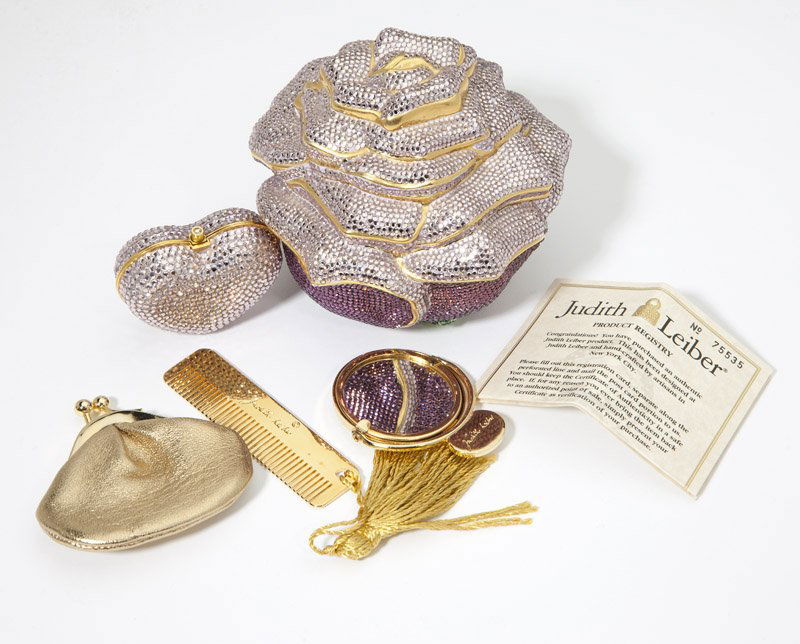 A rose minaudiere and pillbox, Judith Leiber: Each item signed Judith Leiber; pink crystal rose minaudiere comes with chain, coinpurse, mirror, and comb still in tissue; heart pillbox set in the same color pink crystals (approx 1.75 '' H x 2'' W