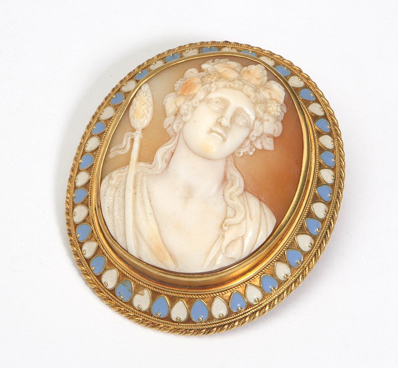 A 10K gold and shell cameo: 14K gold frame brooch with enamel accent centering a shell carving of Greek god Baccus , est:$200/400