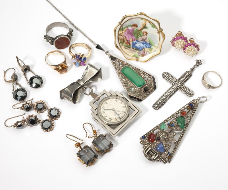 A collection of gold, silver and costume jewelry: Including two art deco silver pendant-brooches, a silver bow lapel watch, gold and hematite earrings, limoges brooch and other items, 17 pcs, est:$400/600