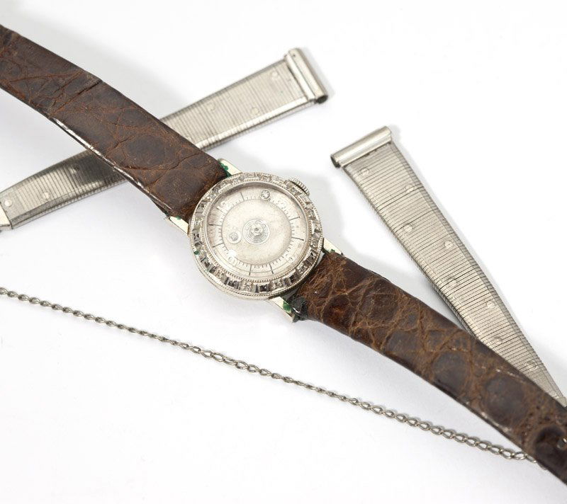 A ladies Le Coultre mystery dial watch: 14K white gold and diamond accent case with leather strap and extra plated metal bands, est:$150/250
