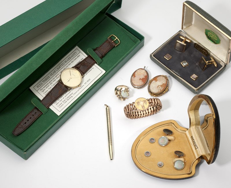 A collection of gold and costume articles: A 14K gold case and leather strapped wristwatch, Croton, quartz with box together with two dress sets, Krementz, an opal and 14K gold ring, one costume bracelet, two costume cameos and one 14K gold pe