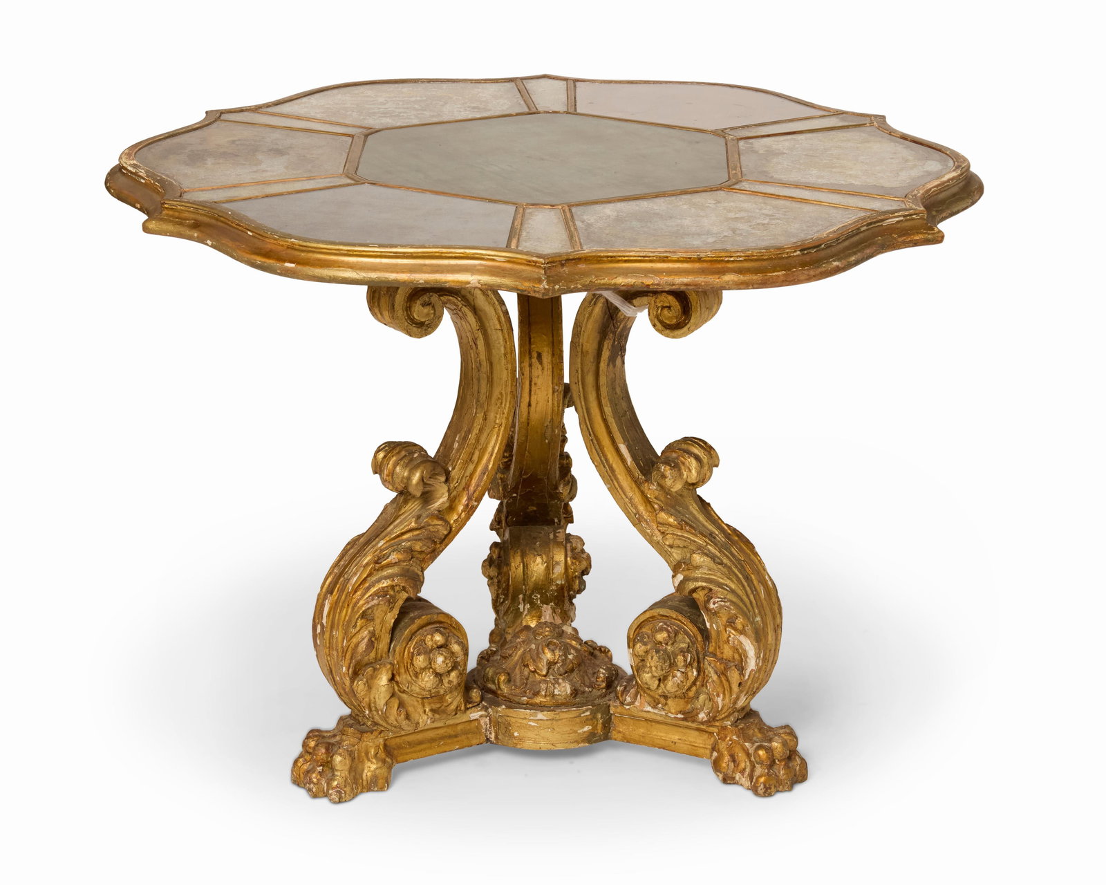 A Baroque-style giltwood table: A Baroque-style giltwood table Late 19th/early 20th century The floriform tabletop with inset mirrored panels above a tripod base with scrolled acanthus legs raised on paw feet Base: 28.25" H x 2