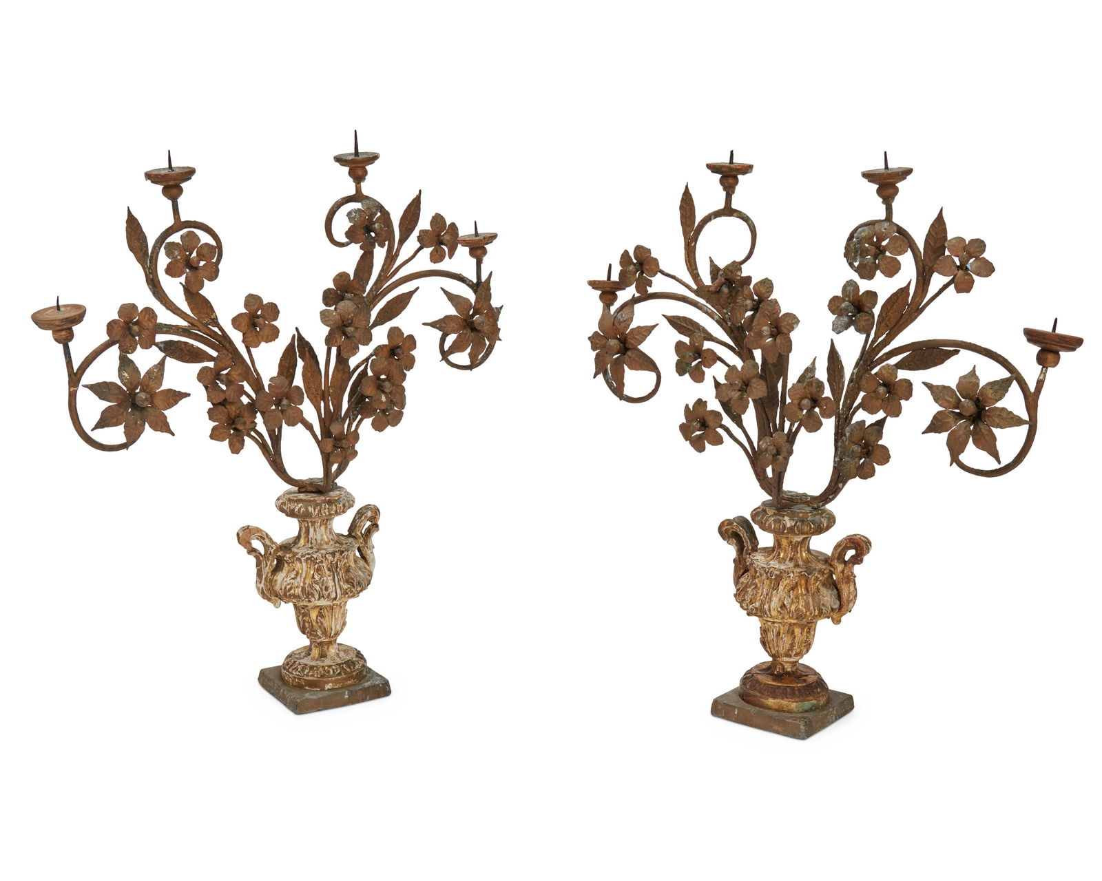 A pair of Baroque-style giltwood and wrought-iron girandoles: A pair of Baroque-style giltwood and wrought-iron girandoles19th centuryThe four-light girandoles, each with a carved giltwood and gesso urn issuing four scrolling floriform candle arms, 2 piecesEach: