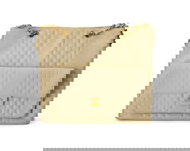 CHANEL: A Vintage Cream Vertical Caviar Leather CC Chain Tote: CHANEL: A Vintage Cream Vertical Caviar Leather CC Chain Tote Circa 1990s; France Marked to interior: Chanel / Copr / Made in France; tag and card: 2713474 A beige cream pebbled calf leather tote