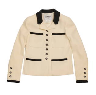 CHANEL: A Vintage White and Black Wool Crop Jacket: CHANEL: A Vintage White and Black Wool Crop Jacket Circa 1990s Label: Chanel Boutique / Made in France / Dry Clean A cropped shaped boucle white wool mix jacket with black collar and edge trim, with