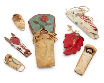 A group of Native American cradleboards and dolls
