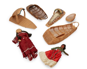 A group of Native American cradleboards and dolls