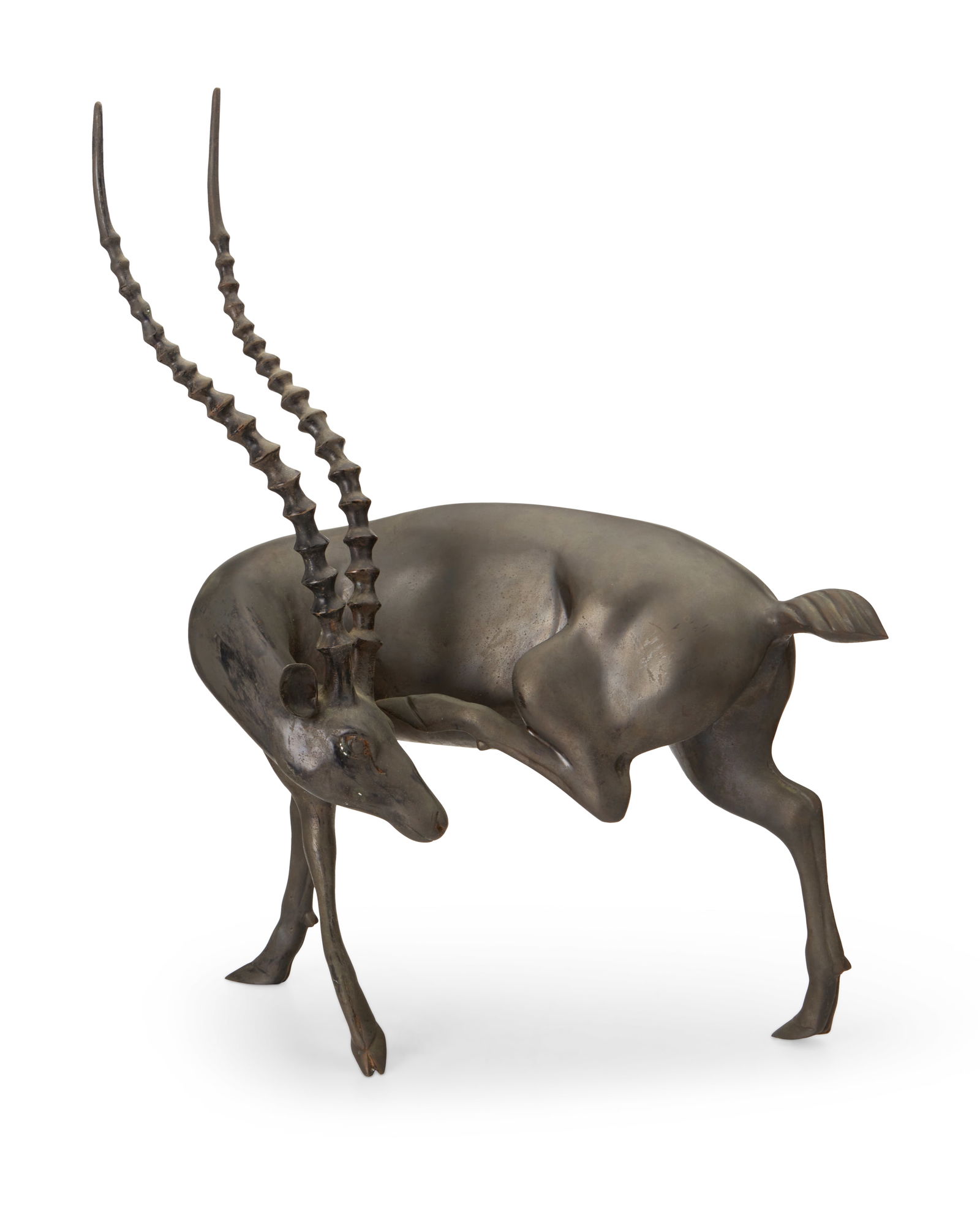 A cast metal gazelle statue: A cast metal gazelle statue20th centuryUnmarkedThe patinated and black-painted figure depicted with rear leg raised23" H x 18.75" W x 10.5" D Provenance:Estate of a Lady, Hollywood, CA
