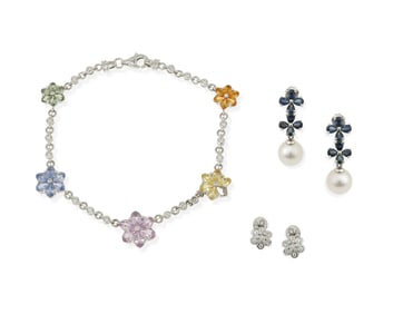 A group of three flower jewelry items