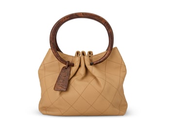 CHANEL: A Beige Quilted Lambskin Faux Wood Handle Bag