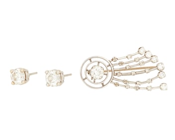 A pair of stud earrings and a pin