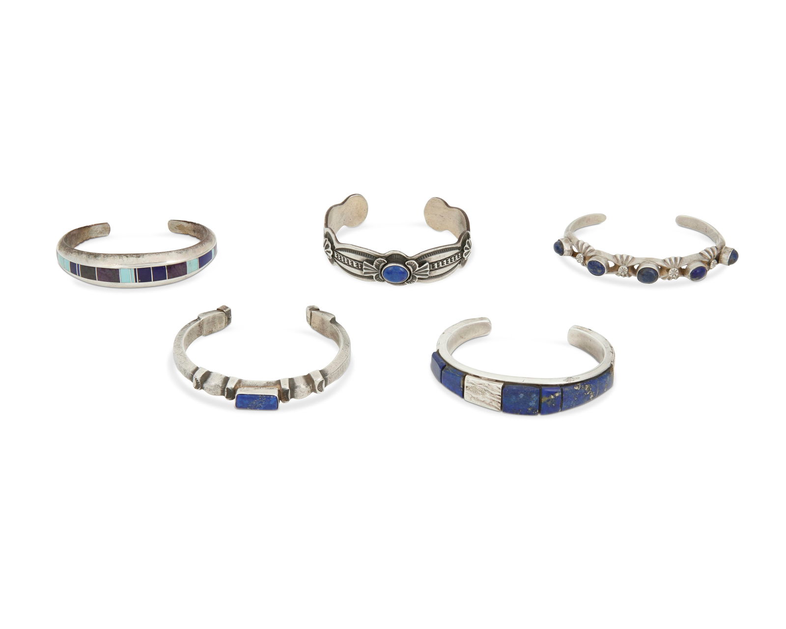 A group of Southwest cast sterling silver and stone cuff bracelets: A group of Southwest cast sterling silver and stone cuff braceletsLate 20th centuryEach marked for sterling and for maker: D. Reeves / A / LJ / FL Begay / TK [conjoined with feathers for Ray Tracey/Kn