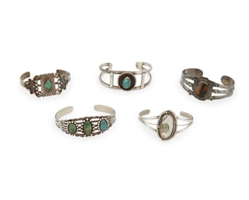 A group of Fred Harvey-style Southwest silver and set stone cuff bracelets