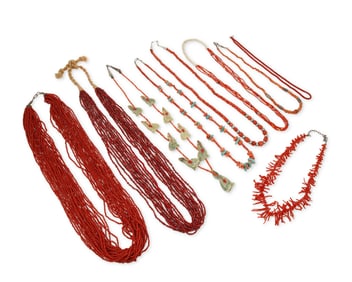 A group of Southwest coral, red glass, and carved stone necklaces