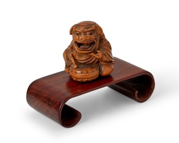 A Japanese carved hardwood Oni netsuke