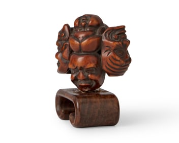 A Japanese carved hardwood Noh mask netsuke