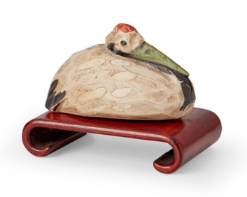 A Japanese polychrome carved wood crane netsuke