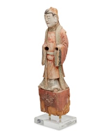 An Asian carved wood figure of an attendant