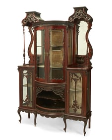 An Edwardian carved mahogany etagere cabinet