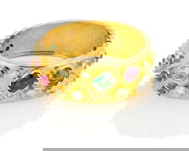 An 18K Gold and Gem-Set Bracelet: An 18K Gold and Gem-Set BraceletOf a hinged design featuring various cuts of green tourmaline, amethyst, citrine, pink tourmaline, peridot, aquamarine and diamondsMeasures: 6 1/2 in., 1 in. wide92.0 g