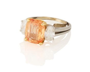A Platinum, Gold, Orange Sapphire and Diamond Ring