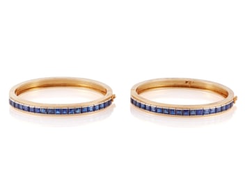 A Pair of 14K Gold and Sapphire Bangles