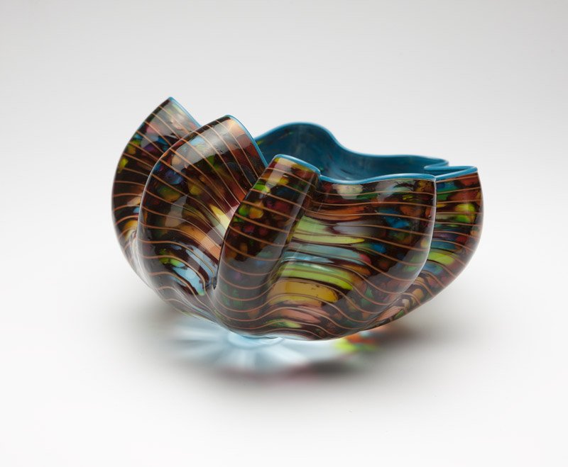 A Dale Chihuly / Portland Press Macchia basket: 2010, signed ''Chihuly'' and ''pp10'', free-form, of multi-colored striated glass with cerulean interior and lip wrap, 5'' H x 9'' Dia., est:$2000/4000