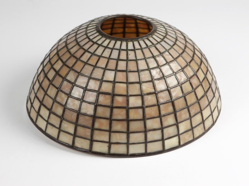 A Tiffany Studios leaded glass lampshade #1411: Early 20th century, stamped ''Tiffany Studios New York'' dome-shaped and inset with caramel-colored glass in a pattern of rectangles in graduated sizes, 6.125'' H x 14.5'' Dia., est:$2000/3000 Note: T