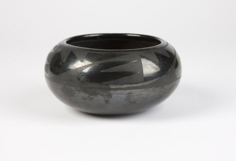 A Marie & Julian San Ildefonso blackware bowl: Circa 1925 - 1943, signed ''Marie + Julian'' (Maria Martinez 1887 - 1980; Julian Martinez 1879 - 1943), of compressed globular form, the polished black ground decorated in matte with a band of repeati