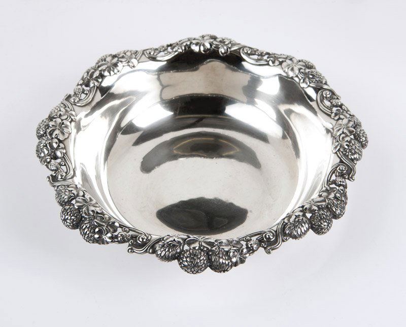 A Tiffany & Co 'Chrysanthemum' sterling bowl: 1902 - 1907 (Directorship of Charles T. Cook), marked ''Tiffany & Co / 15646 Makers 3460 / Sterling Silver / 925 - 1000 / C'', the circular, undulating pierced rim decorated with chrysanthemum sprays