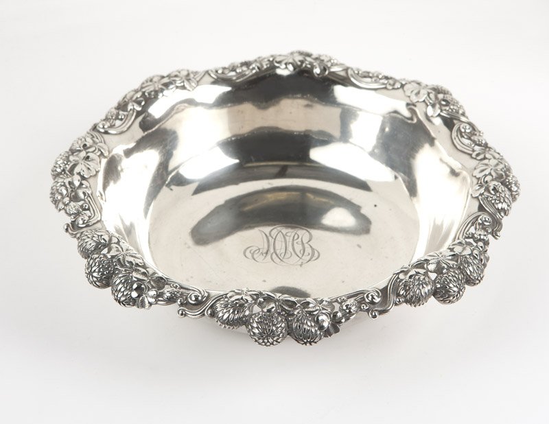 A Tiffany & Co 'Chrysanthemum' sterling bowl: 1907 - 1947 (Directorship of John C. Moore II), marked ''Tiffany & Co / 15646 Makers 5365 / Sterling Silver / 925 - 1000 / M'', the circular, undulating pierced rim decorated with chrysanthemum sprays