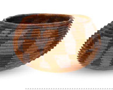 A polychrome California Mission basket: A polychrome California Mission basket Early 20th century; Southern California A coiled globular bowl with four geometric abstract motifs to sides and floral motif to base 4" H x 7.25" Dia.