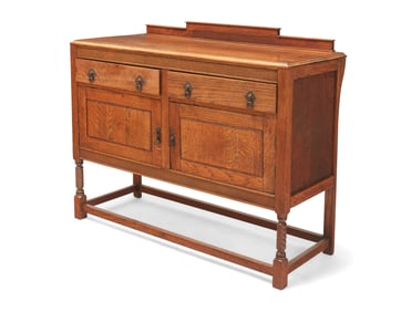 An Arts & Crafts-style carved oak dresser