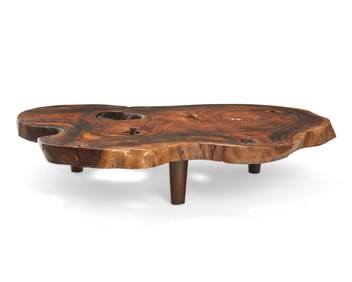 A rustic burlwood live edge coffee table