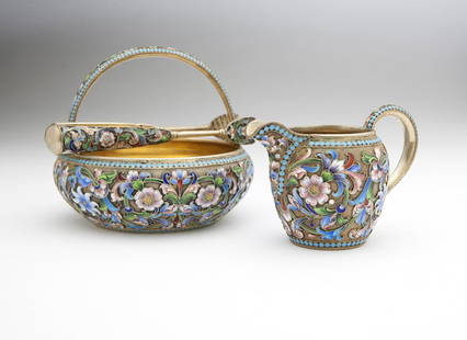 A Russian silver & enamel tea set, Semenova: Circa 1899 - 1908, with left-facing kokoshnik and maker's mark of Maria Semenova, 84 standard silver and cloisonne enamel, comprising: a sugar bowl with swing handle (with handle down 1.875'' H x