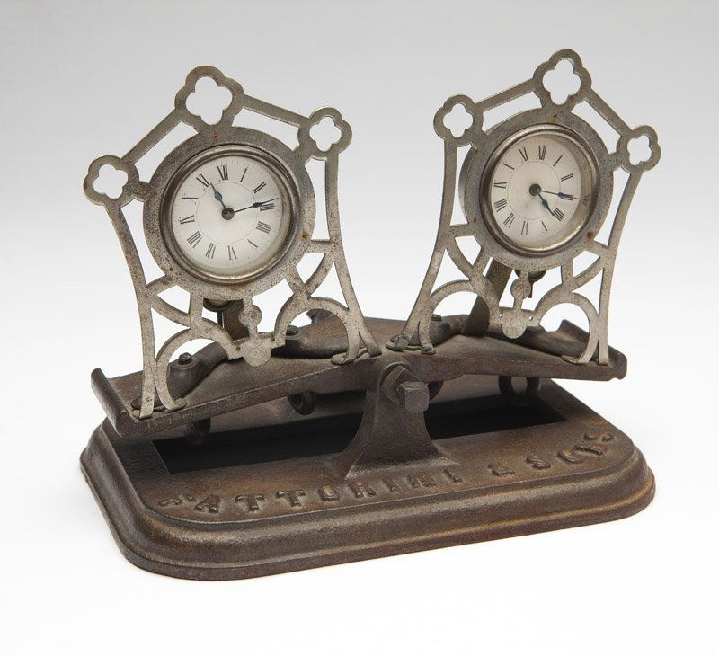A Fattorini & Sons chess tournament clock: the base with cast marks ''Fattorini & Sons'' and ''Bradford'', the dials unmarked, of cast iron, the rocking platform base fitted with two clocks, 6.25'' H x 7.25'' W x 5'' D, est:$1000/1500
