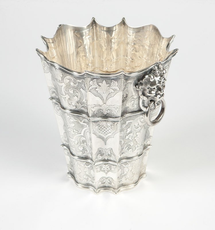 An Italian sterling silver wine cooler: After 1968, Milan, with registration #1623, marked ''925'' and ''Fatto A Mano'' (''Hand Made''), the undulating body decorated with foliate scrolls, lattice and fruit baskets, flanked by grotesque mas