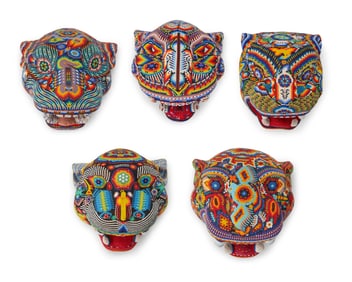 A group of Huichol beaded jaguar masks