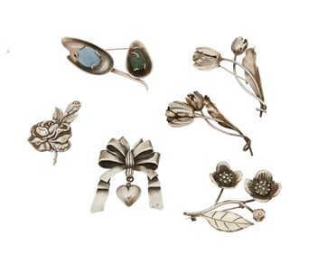 A group of Mexican silver floriform brooches