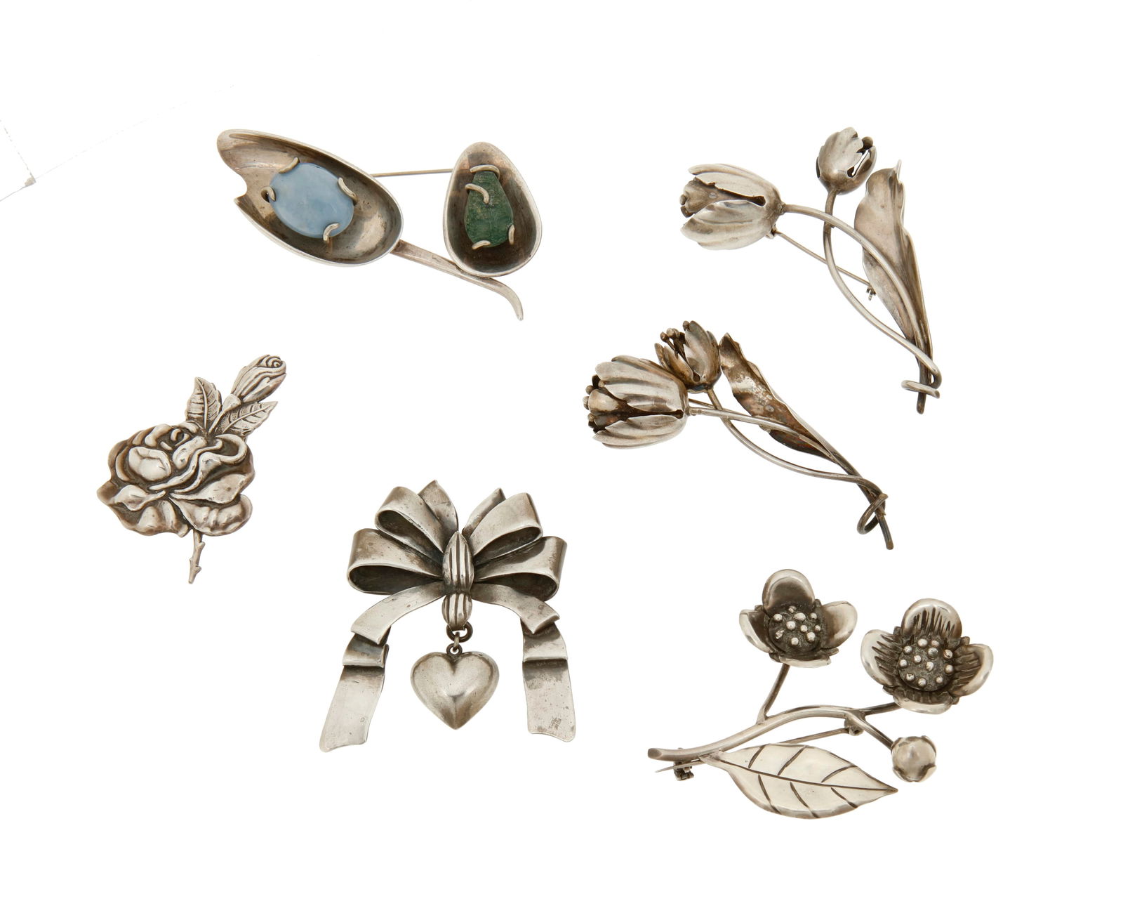 A group of Mexican silver floriform brooches: A group of Mexican silver floriform broochesMid-20th centuryEach variously marked for maker, for Mexico and for sterling; further variously marked: [Design number] / [Eagle 16] / [Eagle 1]Six works in