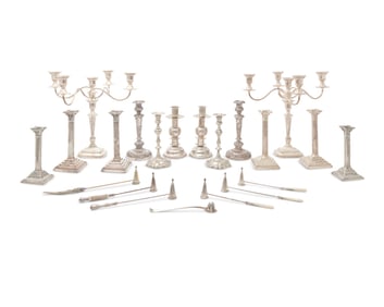A large group of silver-plated candelabra and candlesticks