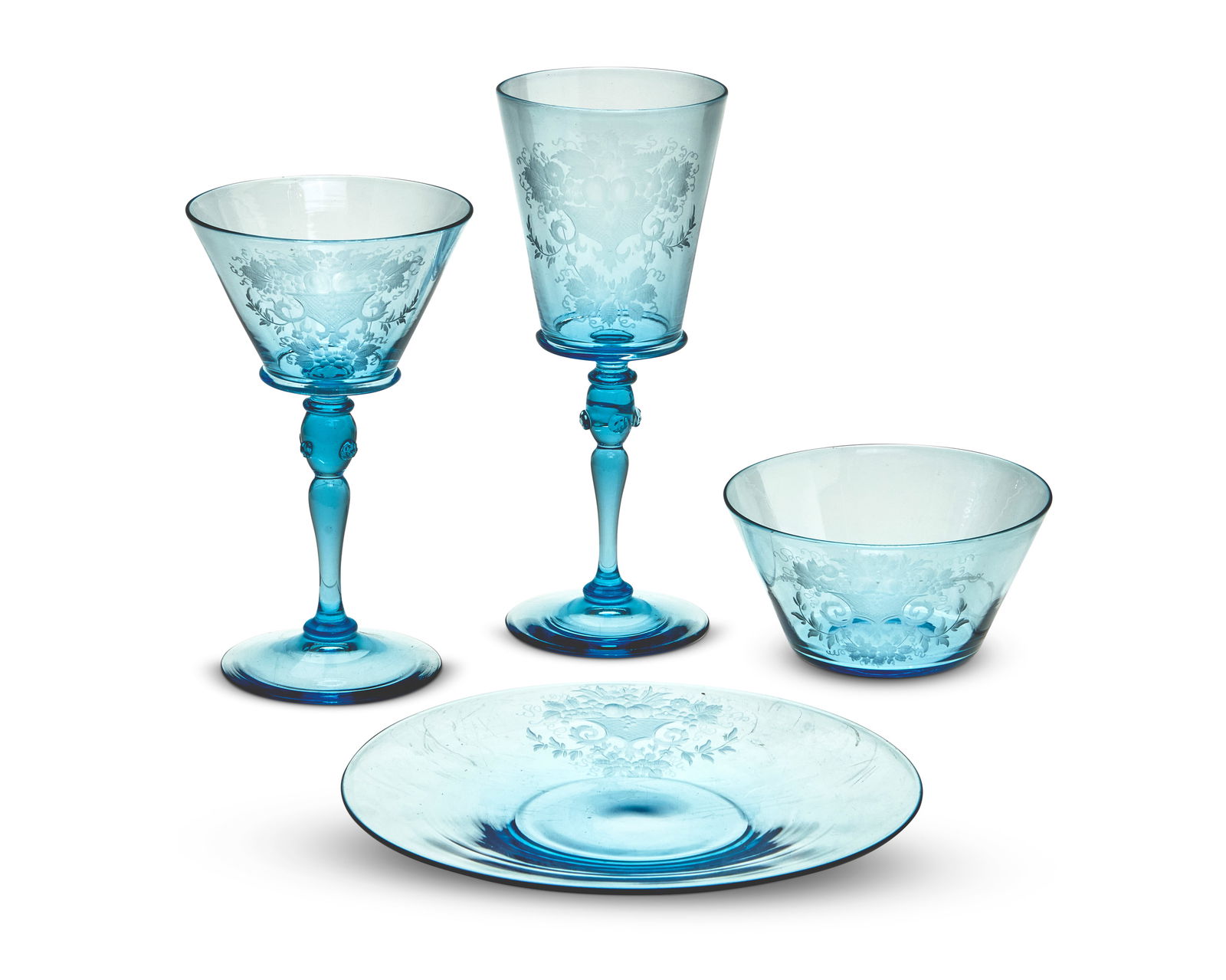 A Steuben wheel-engraved celeste blue glassware service: A Steuben wheel-engraved celeste blue glassware serviceCirca 1930Some pieces with etched factory markEach piece engraved with fruit and floral sprays on a pale blue ground, the knot baluster stem deco