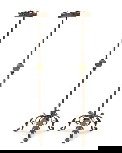 A pair of Spanish Baroque-style wrought iron torcheres: A pair of Spanish Baroque-style wrought iron torcheres19th/20th centuryEach on a tripod leaf-form base issuing a partial twisted standard, surmounted by a leaf-form bobeche2 piecesEach: 87" H x 20" Di