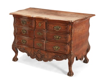 A Louis XV carved walnut commode