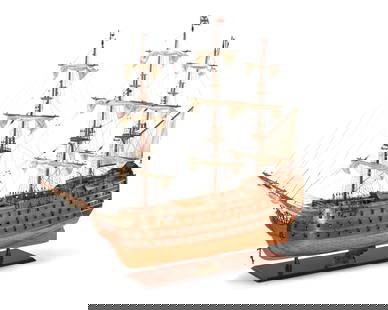 An Old Modern Handicrafts model of HMS Victory: An Old Modern Handicrafts model of HMS VictoryLate 20th centuryWith metal stand: HMS Victory / 1805The wood model with canvas sails60" H x 83" W x 16" D approximately Provenance:From the Collection of
