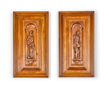 A pair of Renaissance-style carved walnut panels