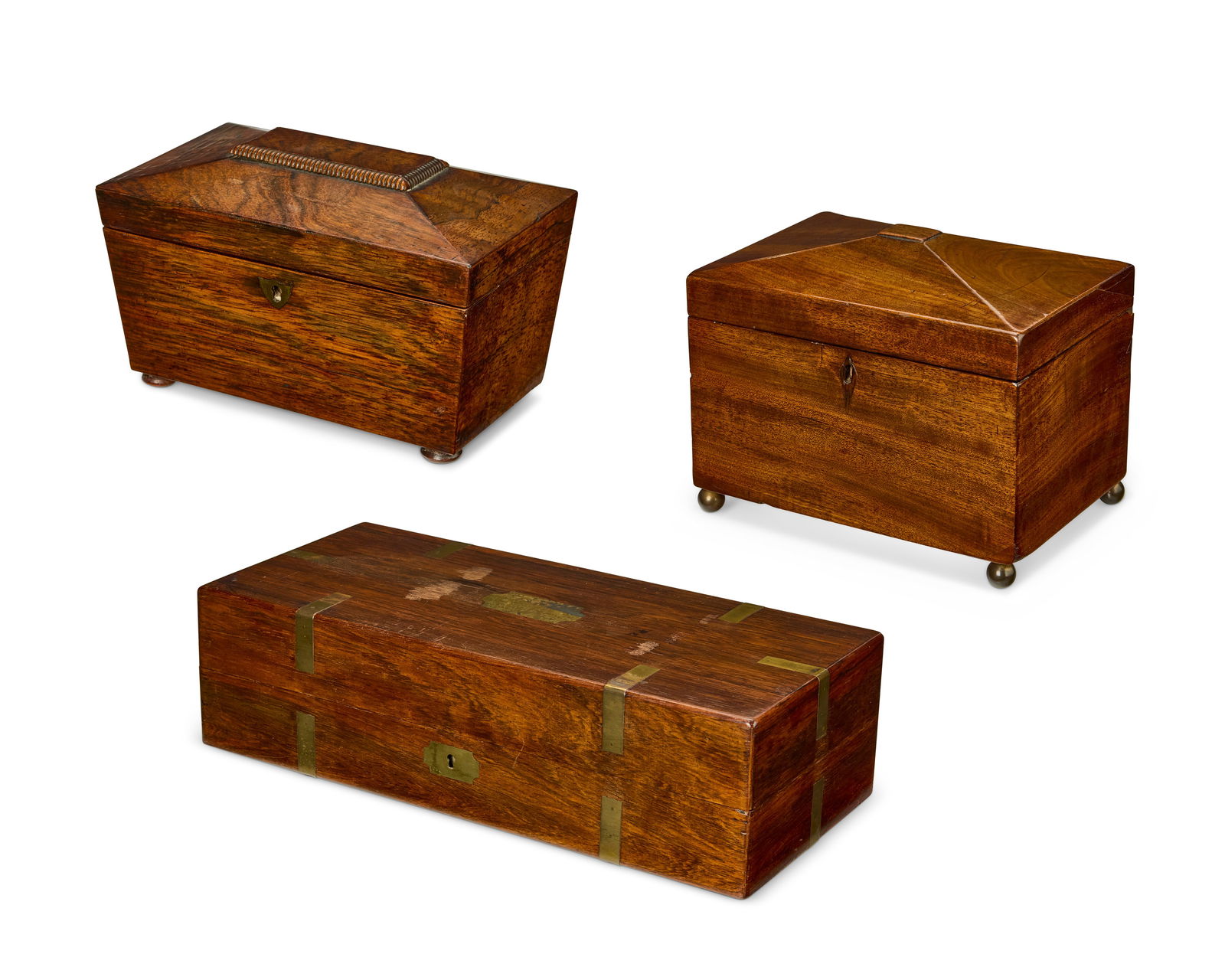 Three English wood boxes: Three English wood boxes19th centuryComprising two Regency tea caddies, one rosewood, one mahogany and a brass-mounted mahogany hinged box with velvet interior fitted for a pistol3 piecesLargest: 4" H