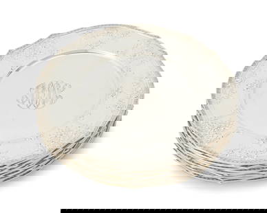 A set of twelve Gorham sterling silver service plates: A set of twelve Gorham sterling silver service platesEarly/mid-20th centuryEach marked for Gorham and for sterlingRetailed by Grogan Company, each rim with foliate swags and suspended flowerheads with