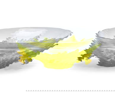 A Daum pate-de-verre bowl: A Daum pate-de-verre bowlLate 20th/early 21st centurySigned and inscribed: Daum / FranceThe clear glass bowl set in a green and yellow p‚te-de-verre daffodil base4.25" H x 12" Dia. Provenance:From t